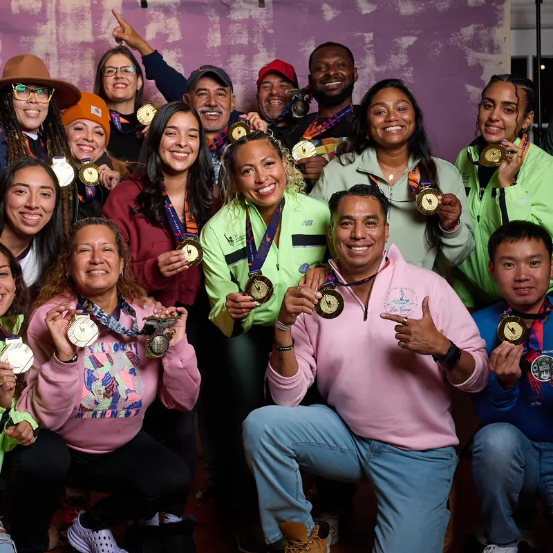 Bronx runners holding up their medals for a group photo