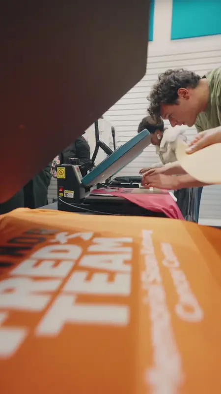 A race shirt being pressed on a heat press in a store