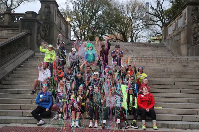 A crowd on the Bethesda Terrace steps throwing streamers