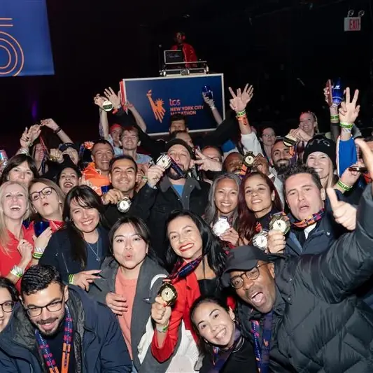 Finishers cheering at a packed after-party